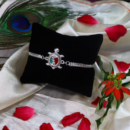 Silver Finish Rakhi With Red-green Enamel
