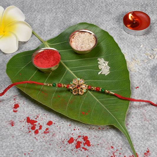 Floral Kundan Rakhi With Red-green Beads And Golden Finish
